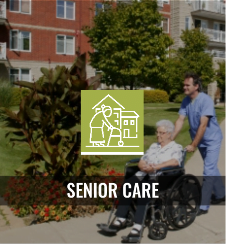 Man in scrubs walking and pushing a senior woman in a wheelchair. Senior care.